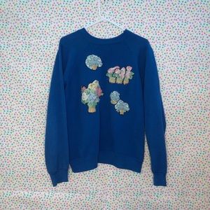 Size medium blue graphic crew neck sweatshirt.